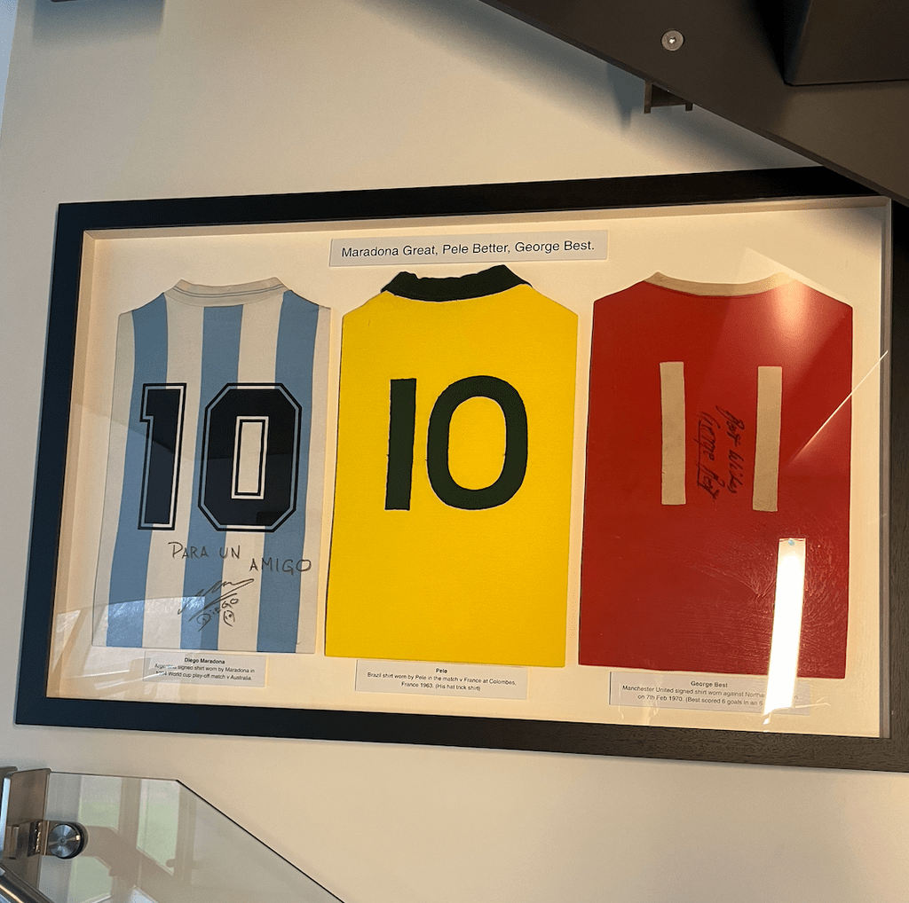 framed football jerseys of Maradona Great, Pele Better, George Best