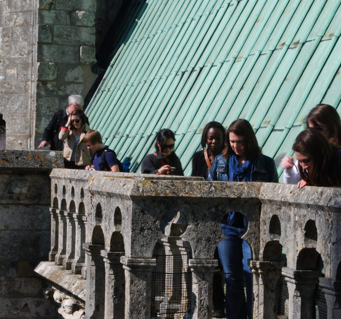 students look down from balcony
