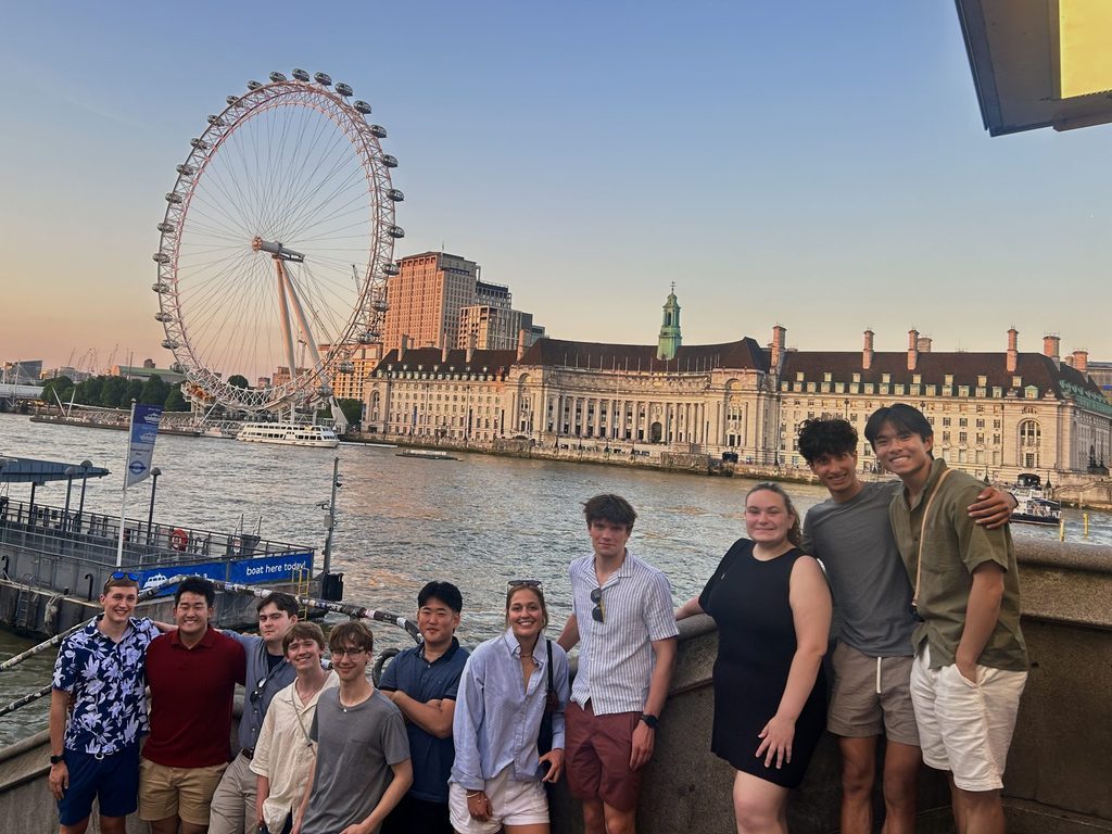 Students pose in front of the London Eye