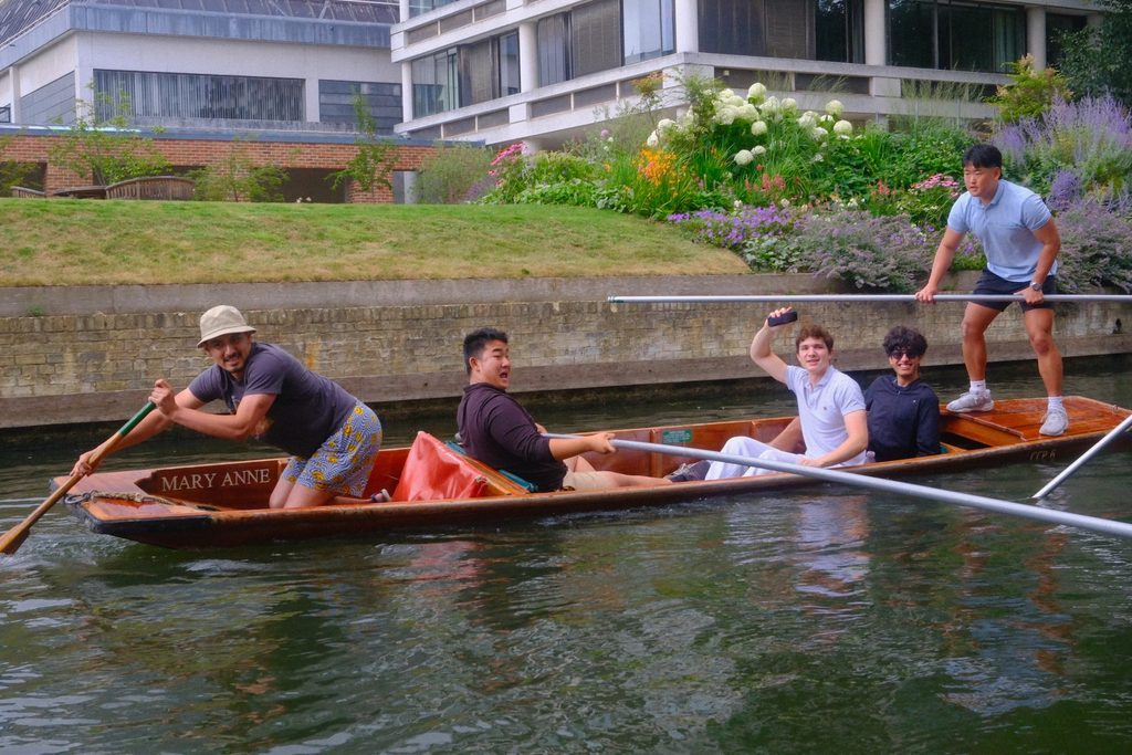Students punting along a canal in Cambridge