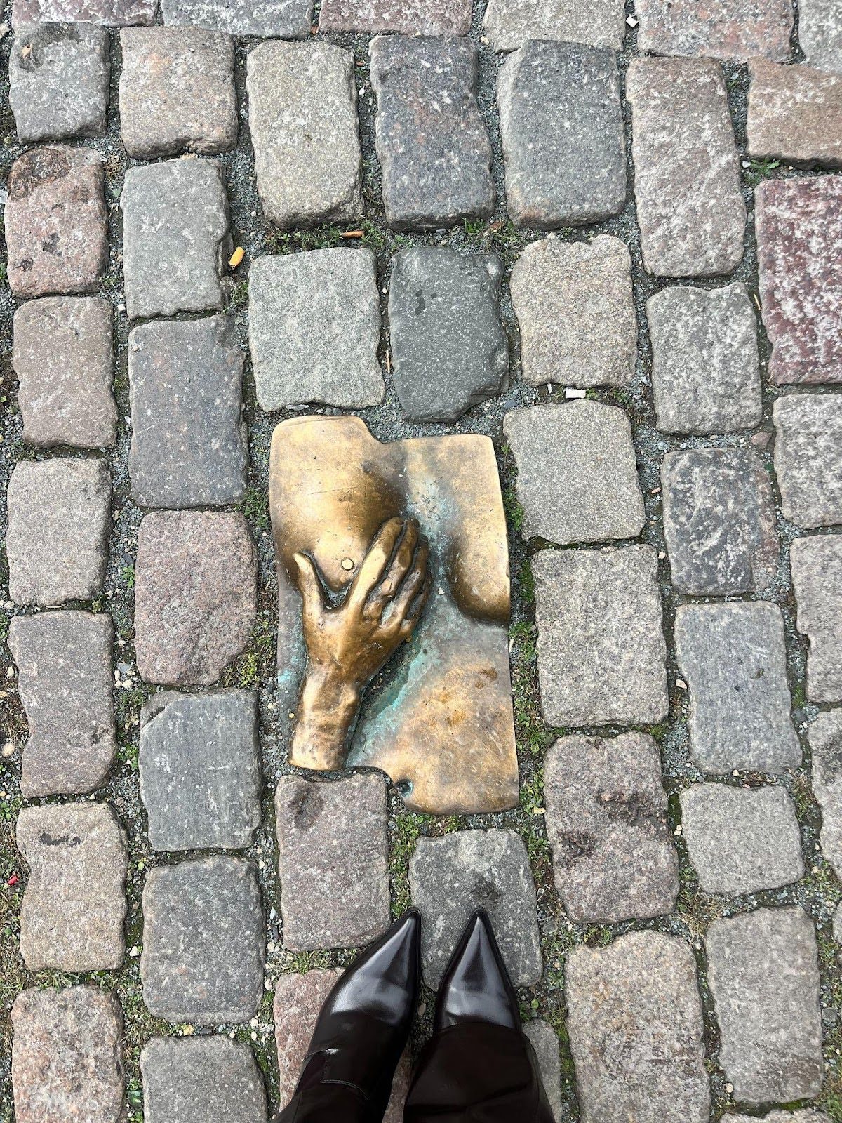 golden statue along brick path