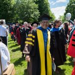 Faculty smiling at students.