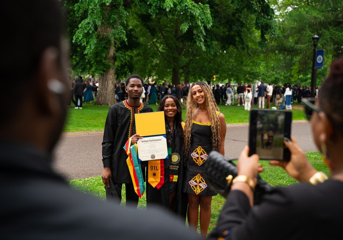 graduate poses for photo