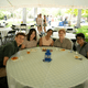 Five people pose for a photo at their table
