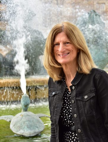 Woman standing in front of a beautiful water fountain