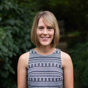 Blonde woman wearing white and blue patterned shirt