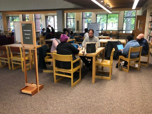 A group of people work together in a library