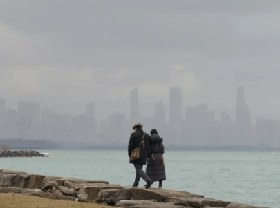 couple walking on shore of lake