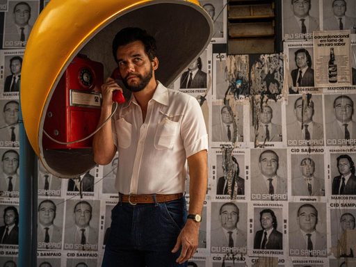 man using red pay phone