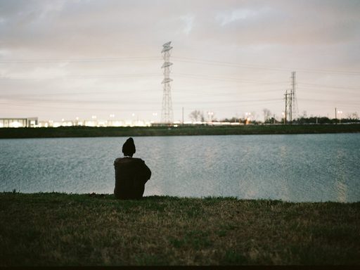 view of figure in distance looking across water at power lines