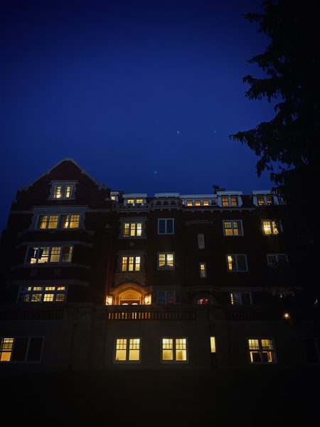 brick building at night with lights on in every window