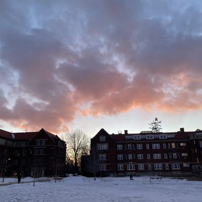 cloudy sunset over brick buildings