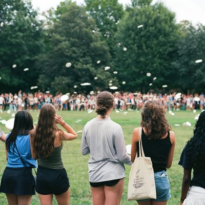 Members of the Class of 2028 take part in the traditional first-year Frisbee toss on the Bald Spot.