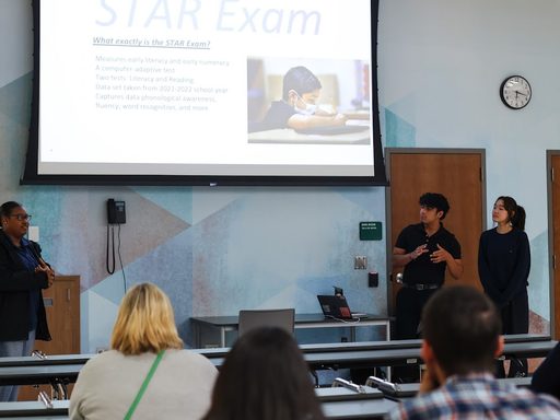 Data Visualization as Activism Students present in front of a small crowd