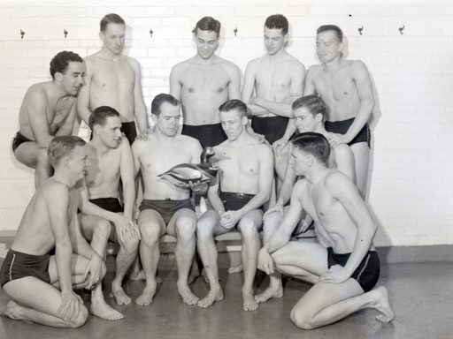 a photo of the mens swim team after winning the 