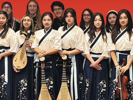 An image of the students in Carleton's Chinese Music Ensemble holding their instruments