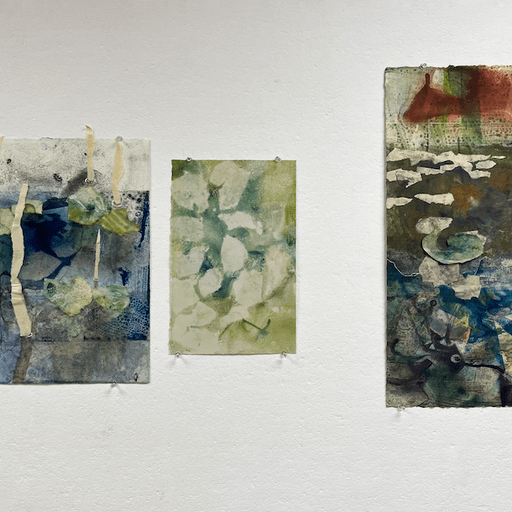 An image of three monotype prints hanging on a wall