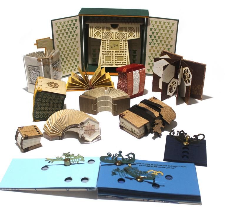 A collection of artist's books by Islam Aly, arranged in a group