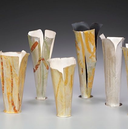 An image of seven elegant vessels made primarily of silver