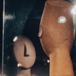 A Human sized crossed armed statue reflecting