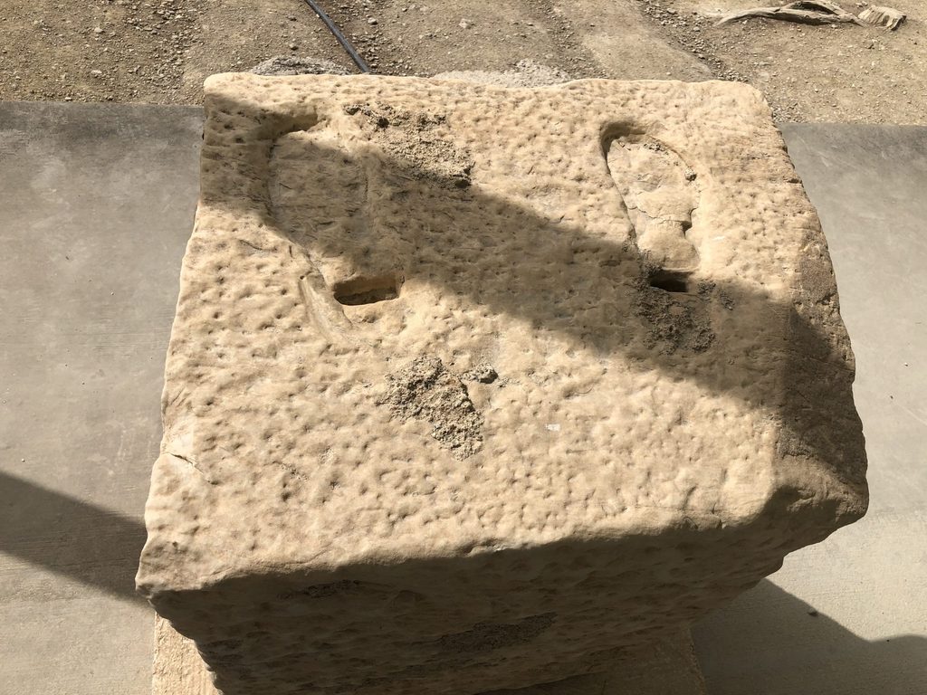 some footprints on column base for bronze statue