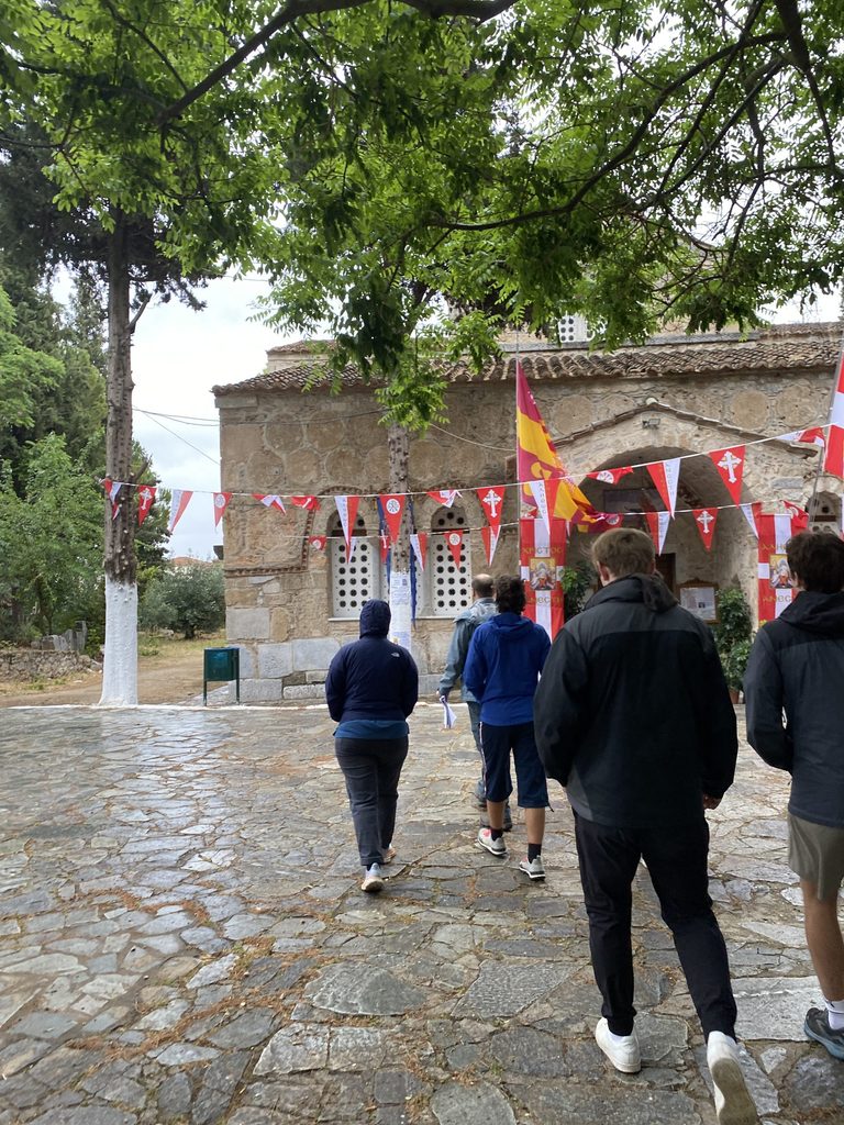 students walk in front of medieval church