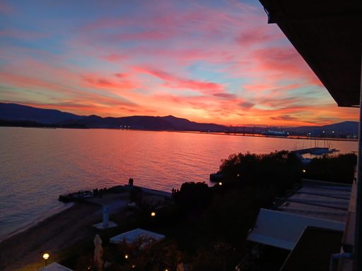 A coastal sunset viewed from a second floor.