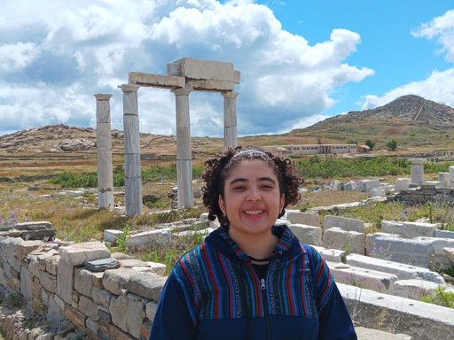 The author posing in front of ancient columns in Delos.