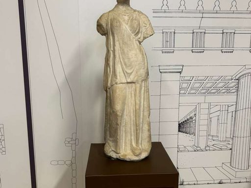 An ancient marble statue of Artemis with arms broken off.