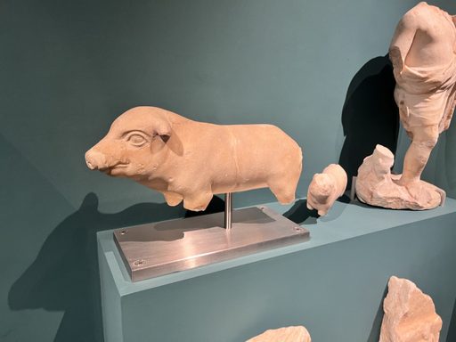 a small ceramic creature. possibly a pig?