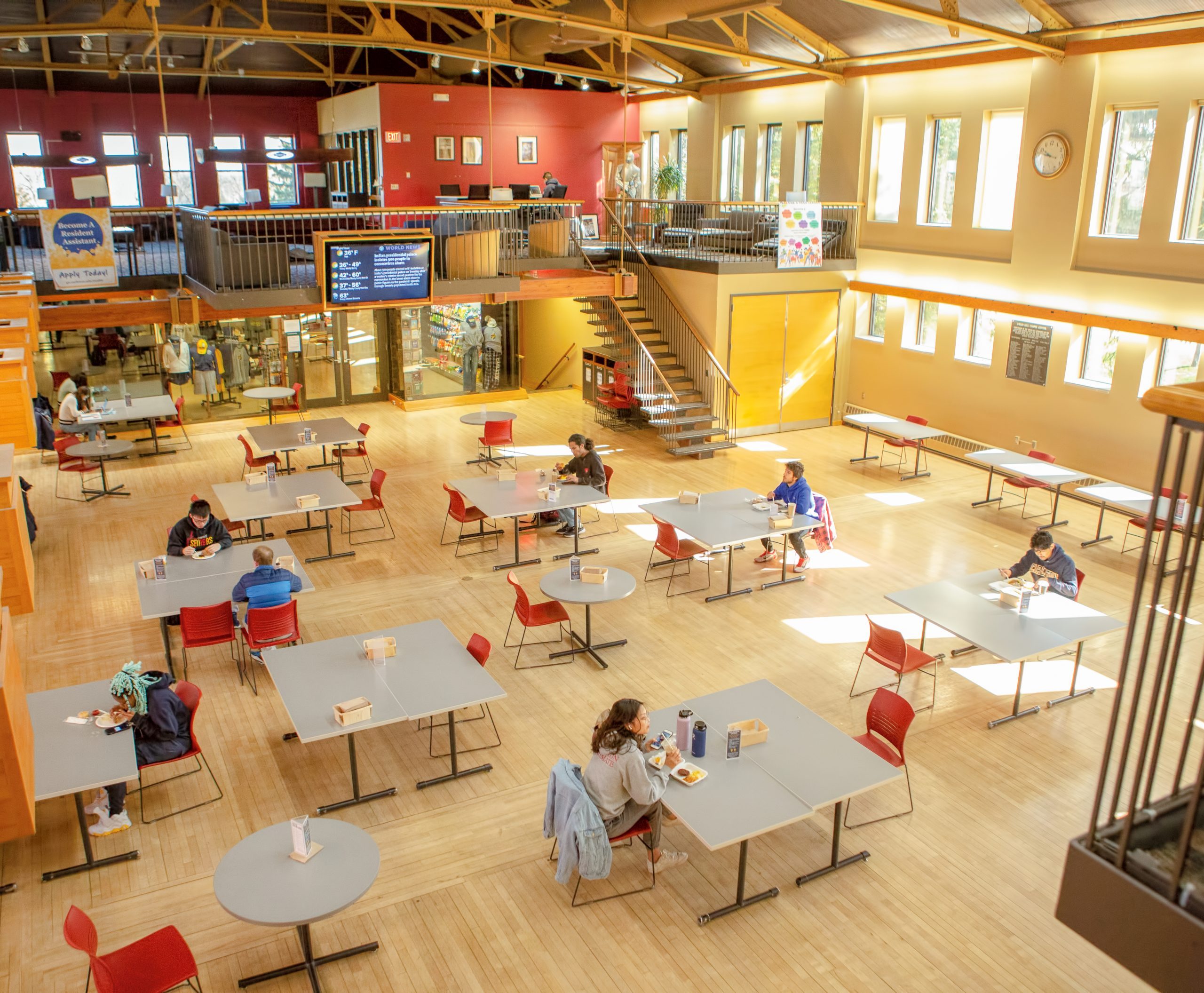 Students sit alone at tables in Sayles-Hill Great Space to respect social distancing.