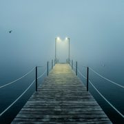 A mist-enshrouded dock on a lake
