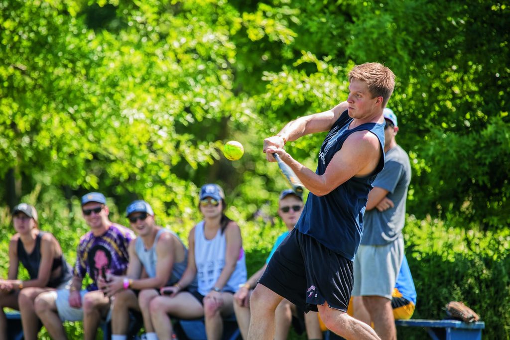 Samuel Brown swings and connects during intramural softball.