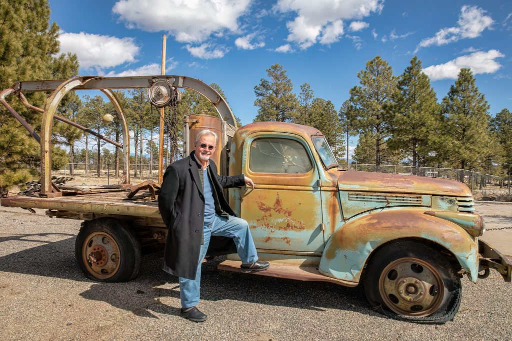 Kai Bird stands beside an antique truck