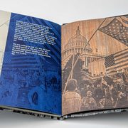 Open book to page showing photos of January 6 protesting at the Capitol
