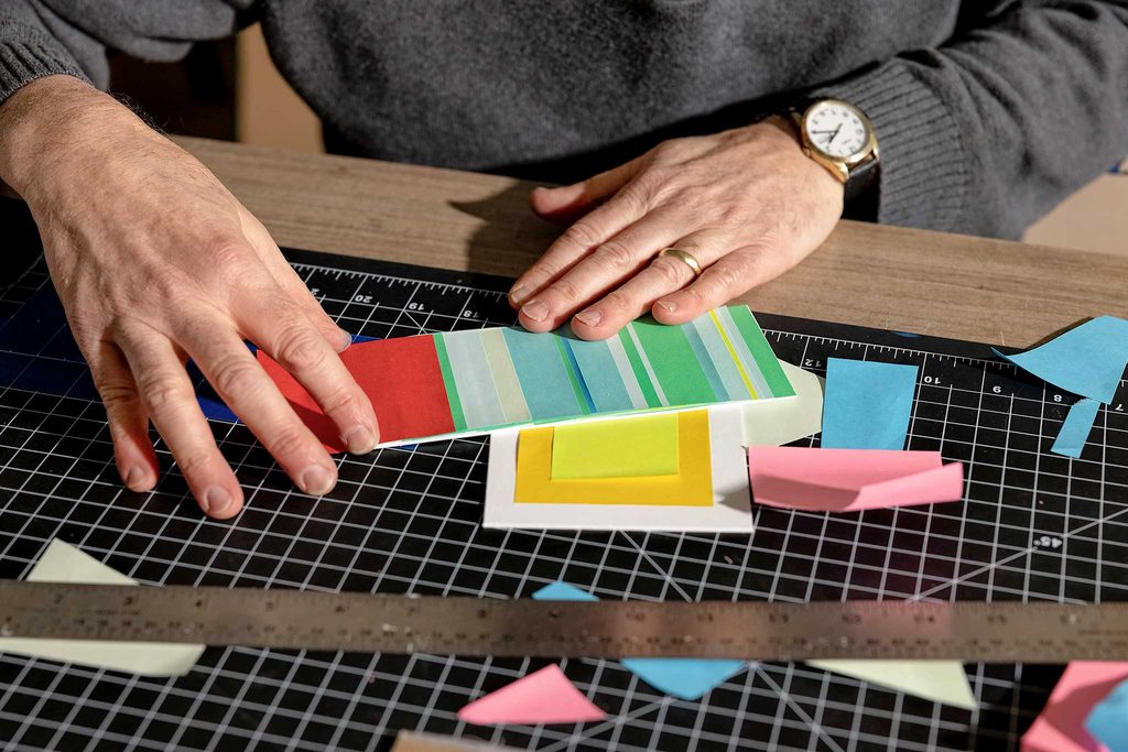 hands overlaying colorful post-its