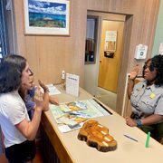two children taking a pledge and a park ranger delivering the oath
