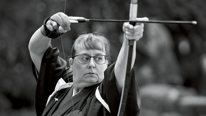 Carly Born holds a traditional Kyudo archery bow