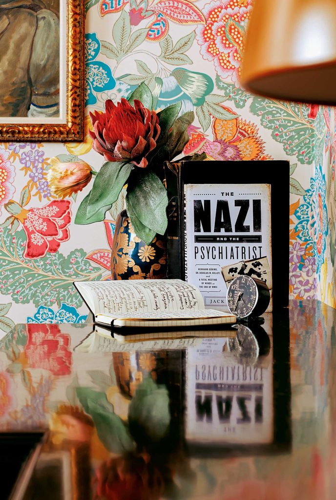 Books on a table, notably one titled "The Nazi and the Psychiatrist" by Jack El-Hai ’79