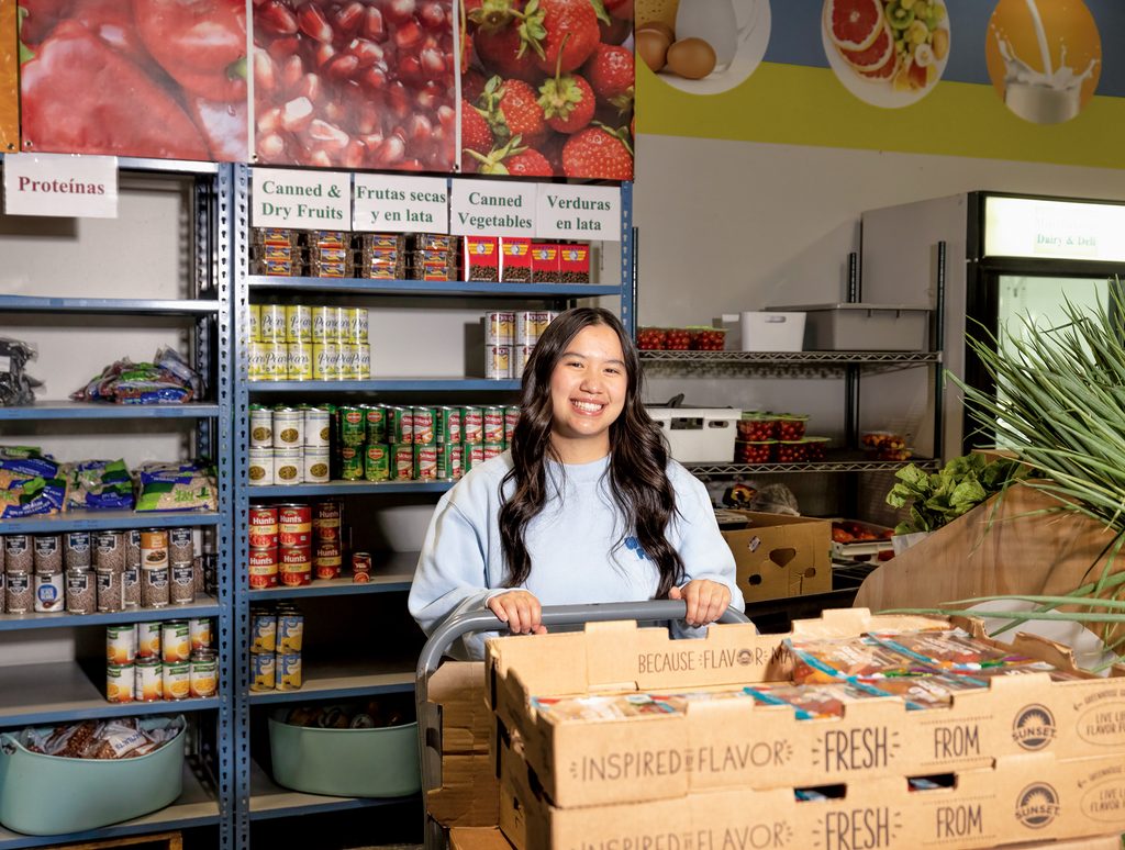 Amanda Ta with boxes and shelves of food