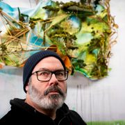 Artist Gregory Euclide in front of one of his sculptural collages