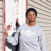 Chantel Johnson-Walker stands on farm steps