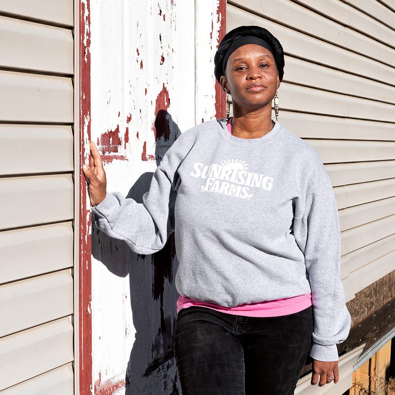 Chantel Johnson-Walker stands on the front step of an old house