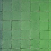Detail of an artwork by Jade Hoyer: 94 square sheets of handmade paper that progress from a soft gray green to a brighter, light green