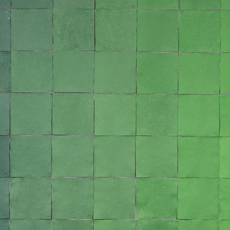 Detail of an artwork by Jade Hoyer: 94 square sheets of handmade paper that progress from a soft gray green to a brighter, light green