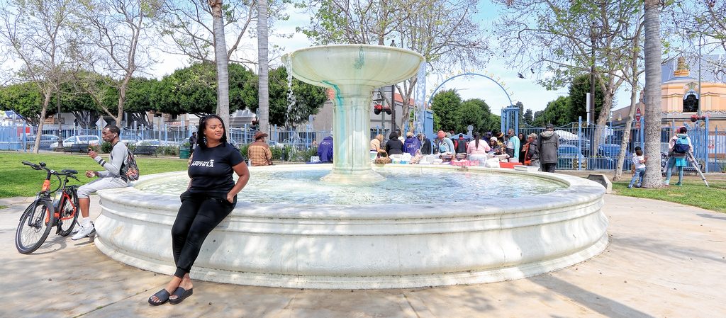 Janae Green sits outdoors on a fountain