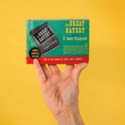 hand holding THE GREAT GATSBY, armed services edition