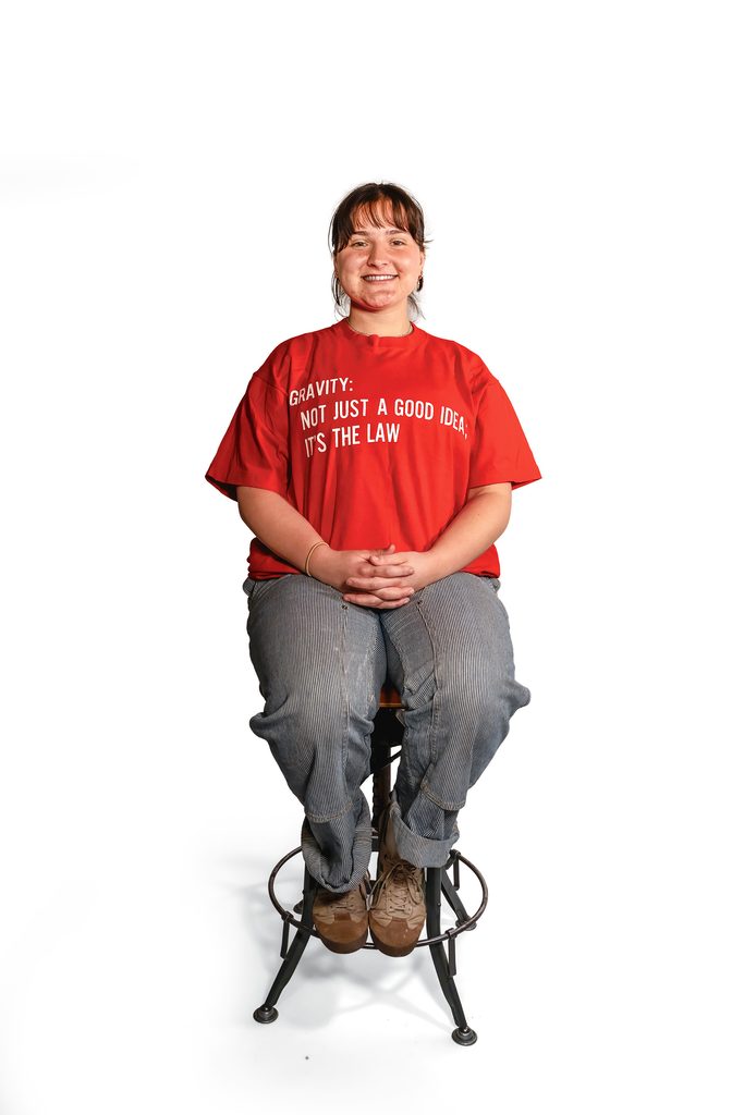 student seated wearing red physic department tshirt