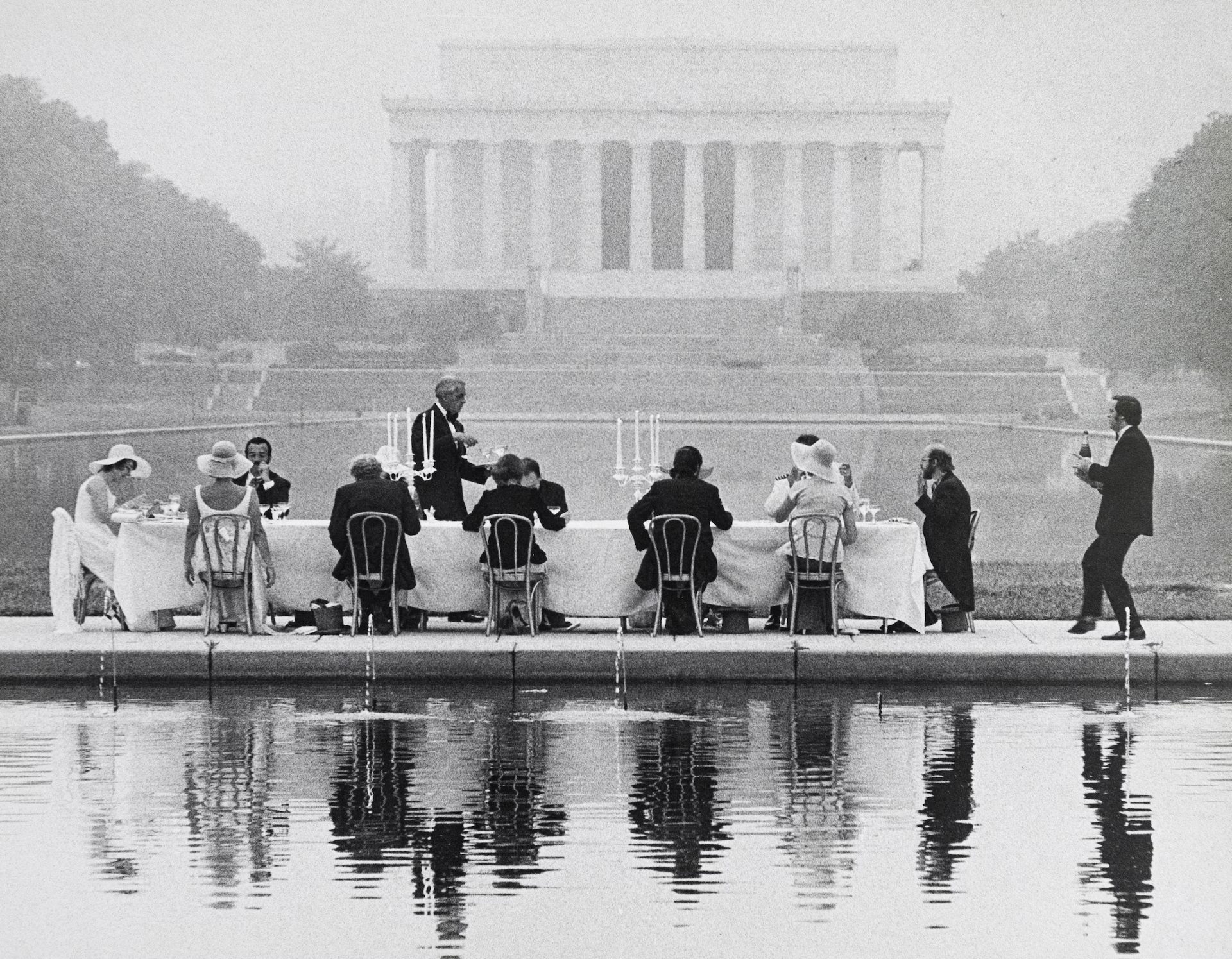 Black & white photo of a group of well-dressed people eating a fancy breakfast on the National Mall in Washington DC in 1974