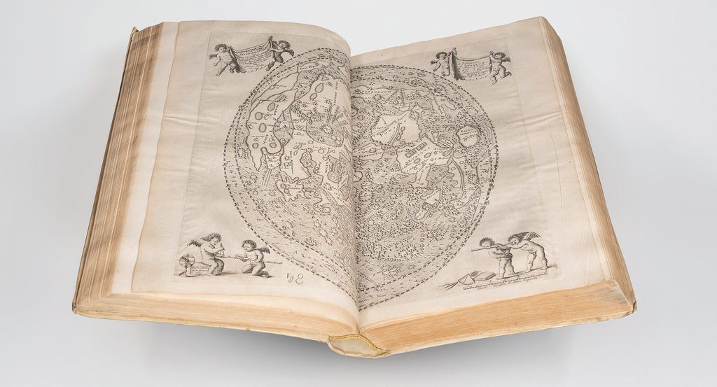 antique, open book with moon drawing
